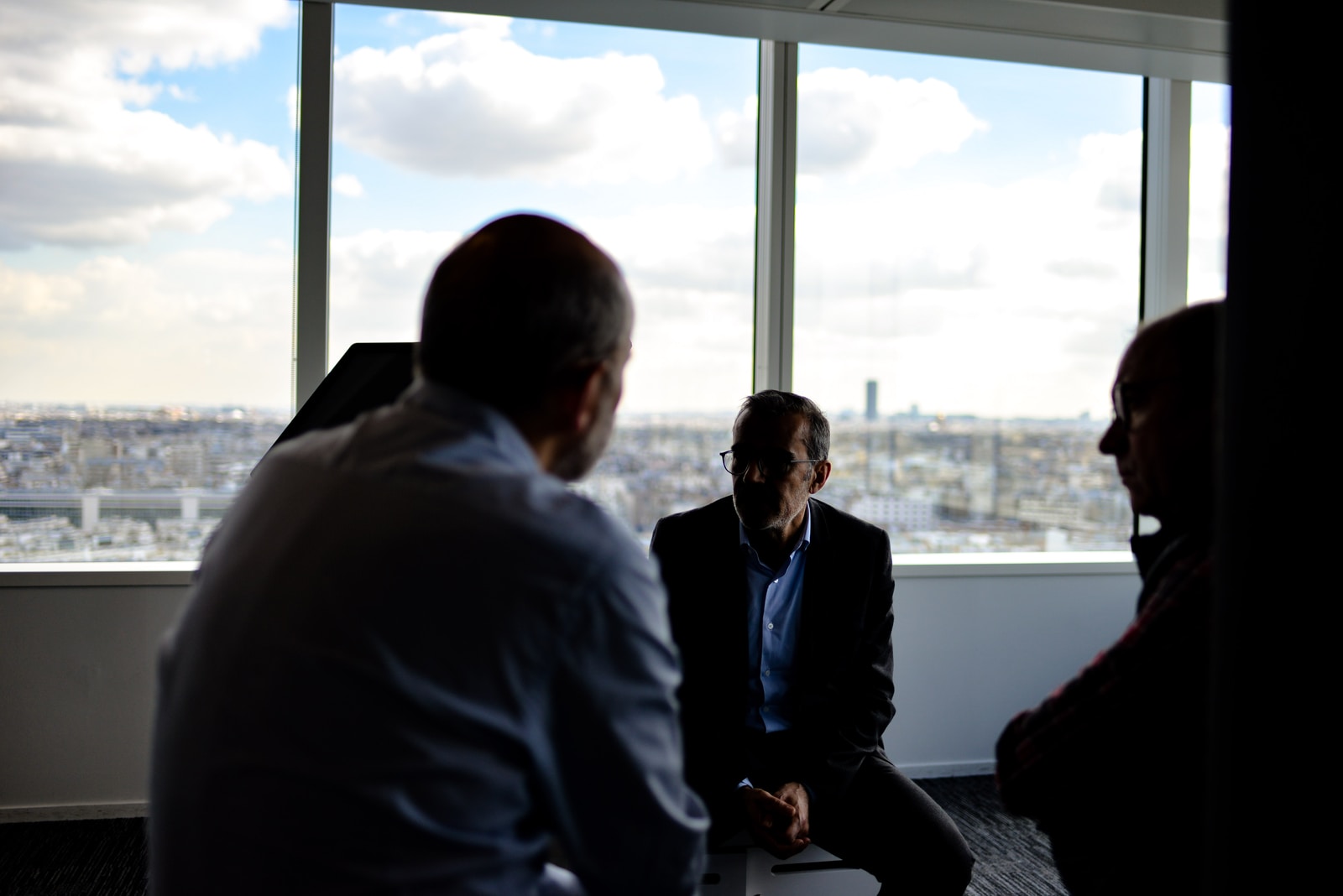 people sitting near window having conversations